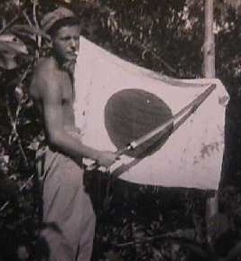 WWII US Marine holding captured Japanese flag